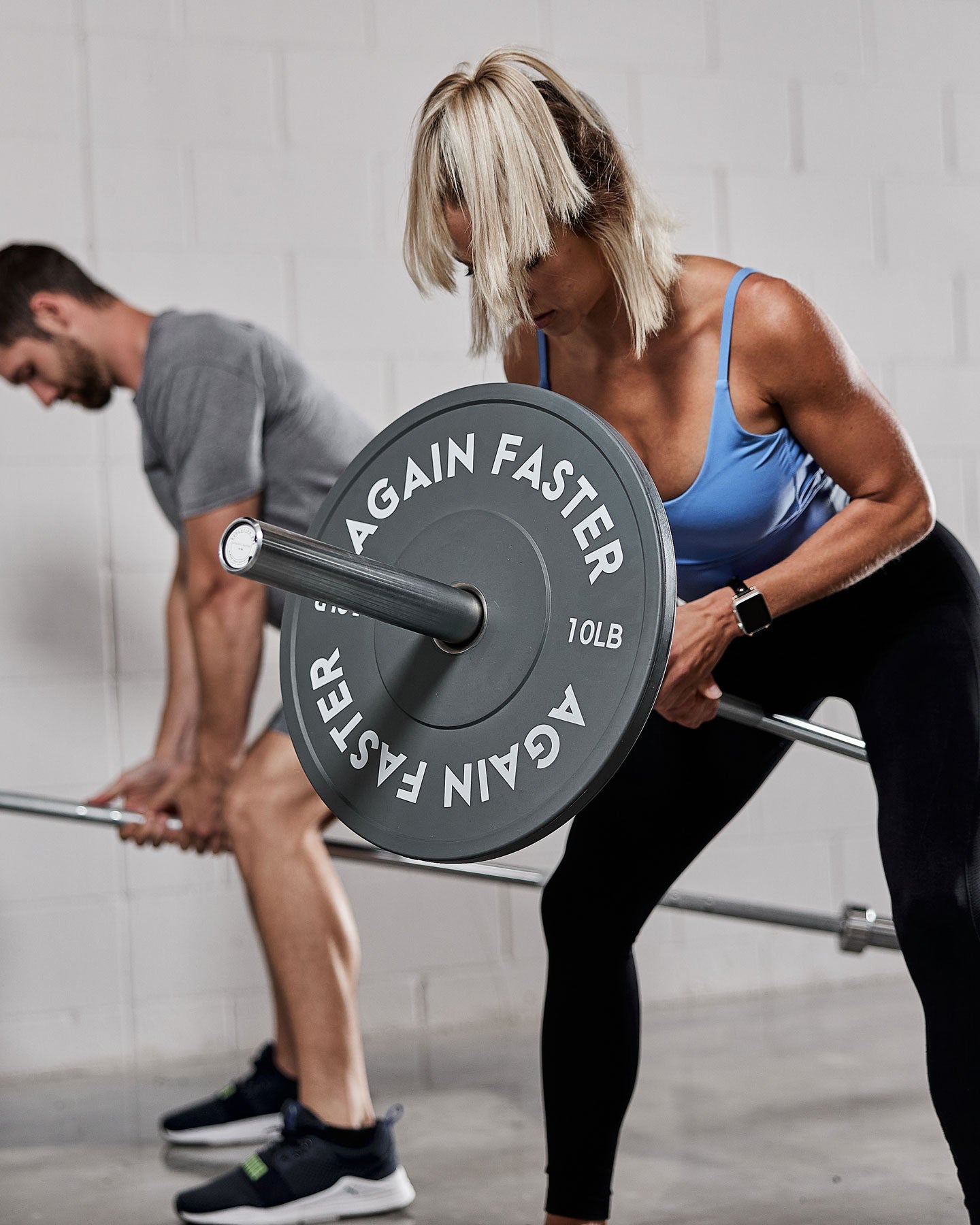 landmine rows with barbell and bumper plates